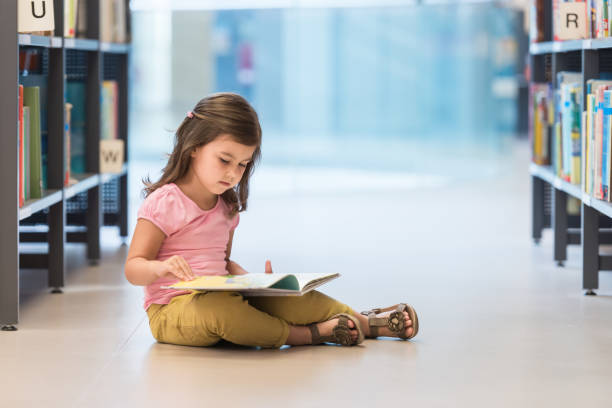 istock Little Girl Study In Public Library 1079675990