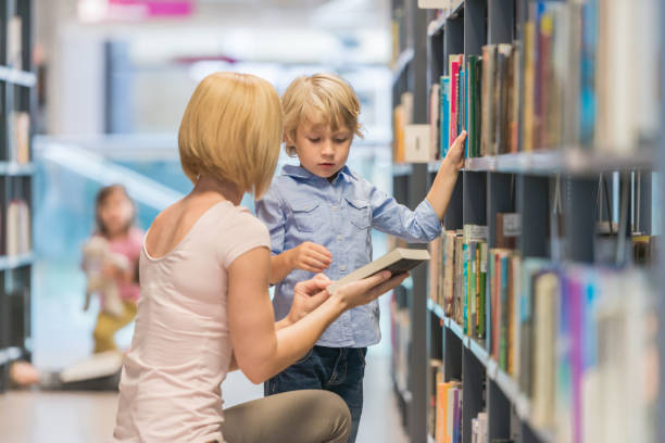 istock Mother And Son In Public Library 1079676420