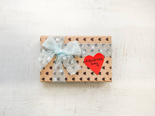 istock Box with a gift, tied with a ribbon, note with sweet words 1079685294