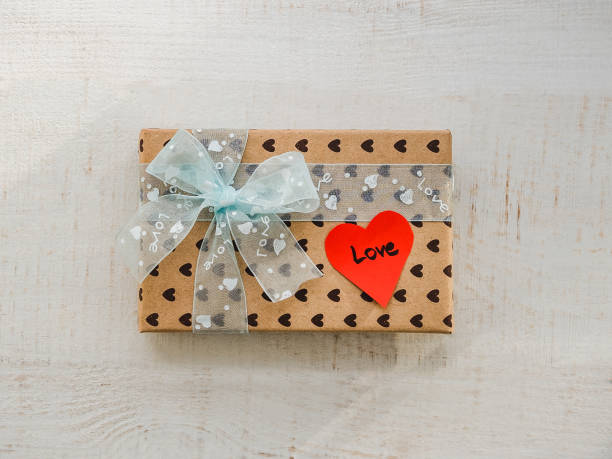 istock Box with a gift, tied with a ribbon, note with sweet words 1079685458