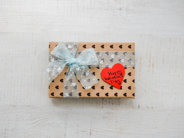 istock Box with a gift, tied with a ribbon, note with sweet words 1079685518