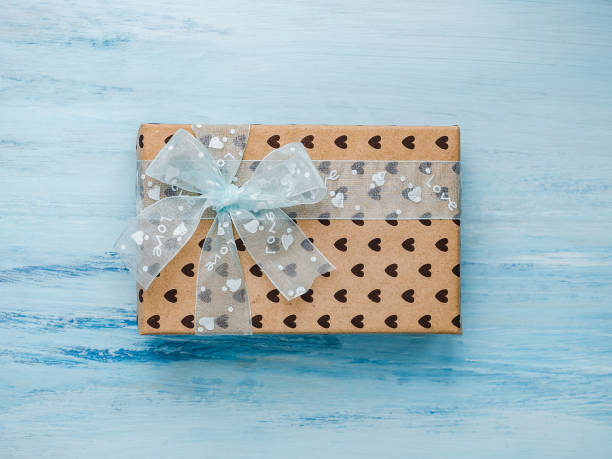 istock Box with a gift, tied with a ribbon, note with sweet words 1079685550