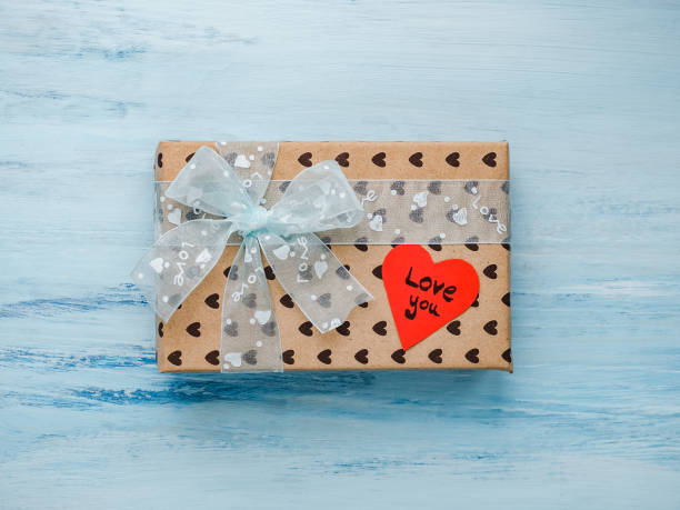 istock Box with a gift, tied with a ribbon, note with sweet words 1079685562
