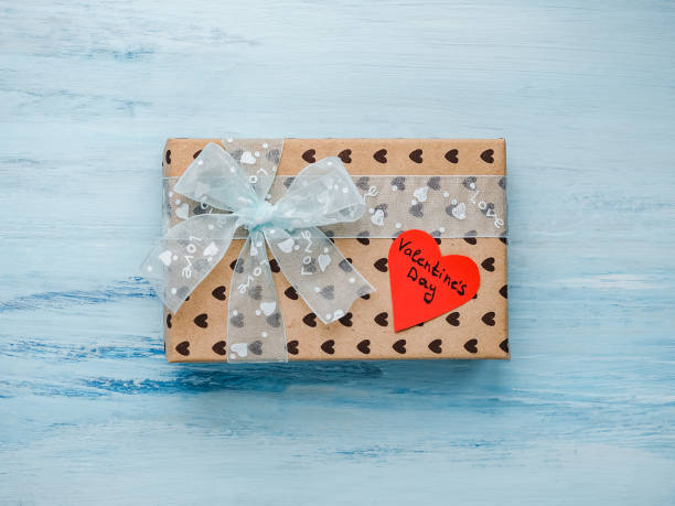 istock Box with a gift, tied with a ribbon, note with sweet words 1079685676