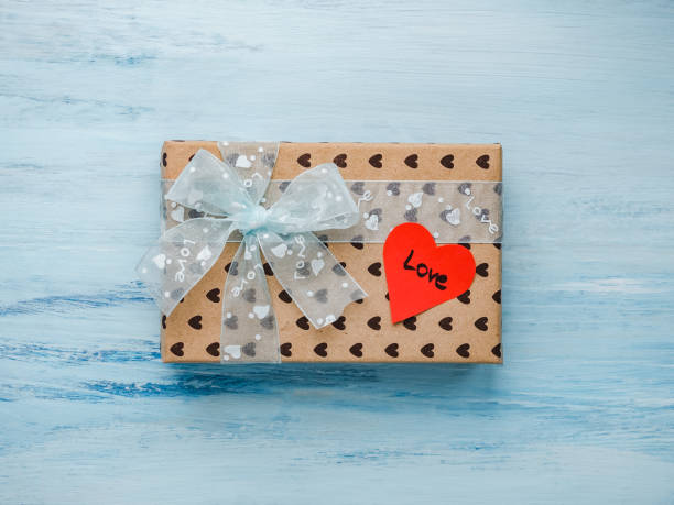 istock Box with a gift, tied with a ribbon, note with sweet words 1079686070