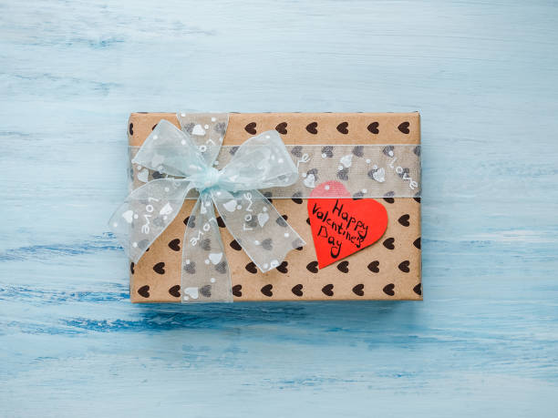 istock Box with a gift, tied with a ribbon, note with sweet words 1079686432