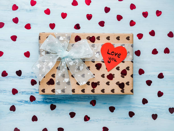 istock Box with a gift, tied with a ribbon, note with sweet words 1079687802