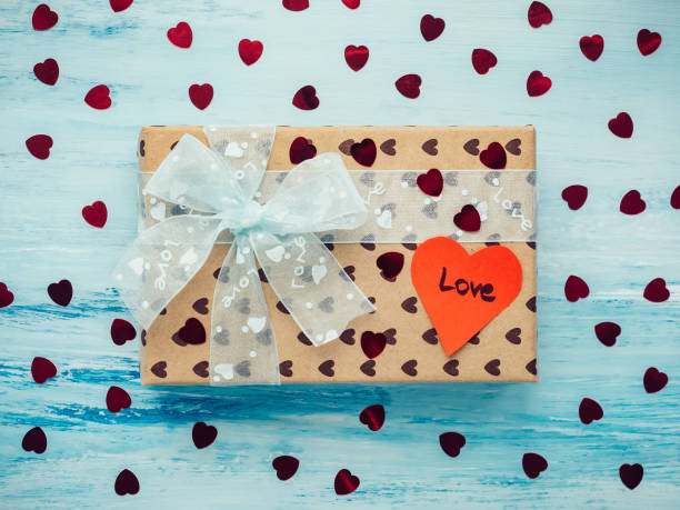 istock Box with a gift, tied with a ribbon, note with sweet words 1079687922