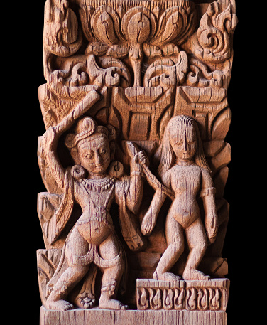 Abduction of Sita - ancient Nepalese wooden carving at the column in palace on Durbar square in Patan, Kathmandu valley, Nepal