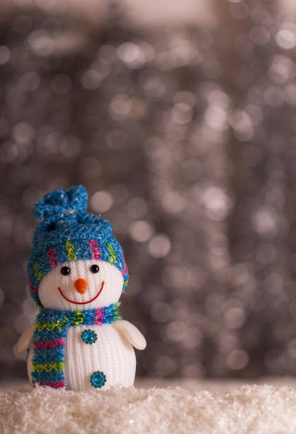 istock Smiling snowman and snowflakes on gray background with bokeh effect 1079690216