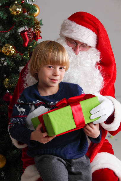 istock Boy on santa claus knees 1079692954