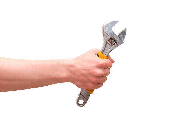 Hand holding adjustable wrench isolated on white background
