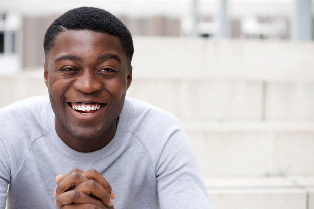 istock Close up happy young african american man laughing with hands clasp 1079696228
