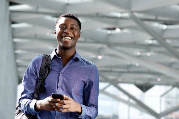 istock african american young man with bag and cellphone 1079696416