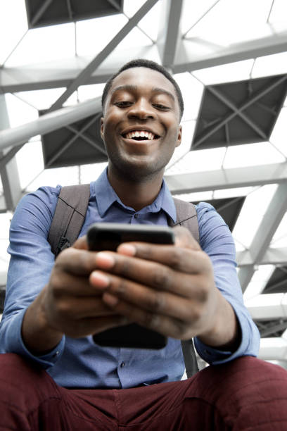 istock young african man looking at cellphone 1079696494