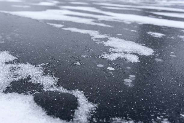 istock freeze bubbles in solid layer of ice of a frozen river 1079698766