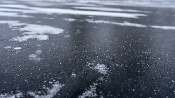 istock thick solid layer of ice of frozen river 1079698834