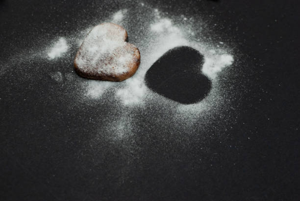 istock Angled view of a cookie with sugar powder on black background 1079701160
