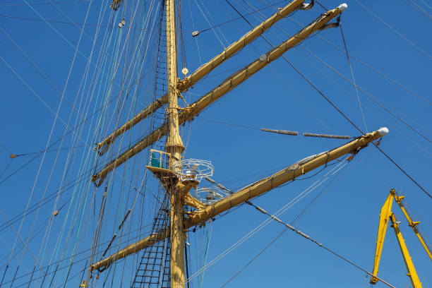 Masts of a sailing ship with the lowered sails with blue sky on the background. Masts of a sailing ship with the lowered sails with blue sky on the background. krusenstern stock pictures, royalty-free photos & images