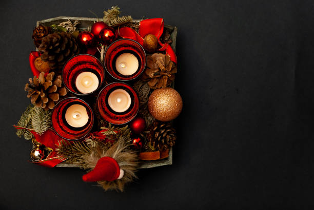 istock Top view of Advent wreath on black background with some copy space - four candles burning - fourth advent 1079701364