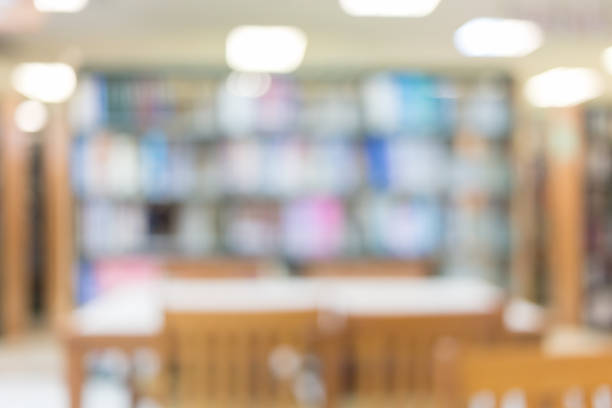 istock library with table desk and bookshelf, abstract blur defocused background 1079706694
