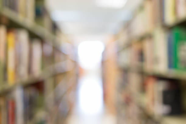 istock books on bookshelf in library, abstract blur defocused background 1079706712
