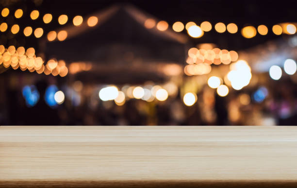 istock Empty wooden table in front of abstract blurred festive background with light spots and bokeh for product montage display of product 1079711658