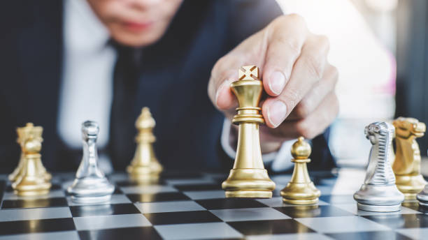 istock Businessman playing chess game reaching to plan strategy for success, thinking for planning overcoming difficulty and achieving goals business strategy for win, management or leadership concept 1079717478