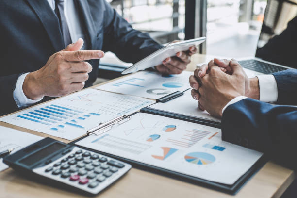 istock Two executive discussing company growth project success financial statistics, Partner meeting professional investor working start up project for both company with document, laptop and digital tablet 1079717526