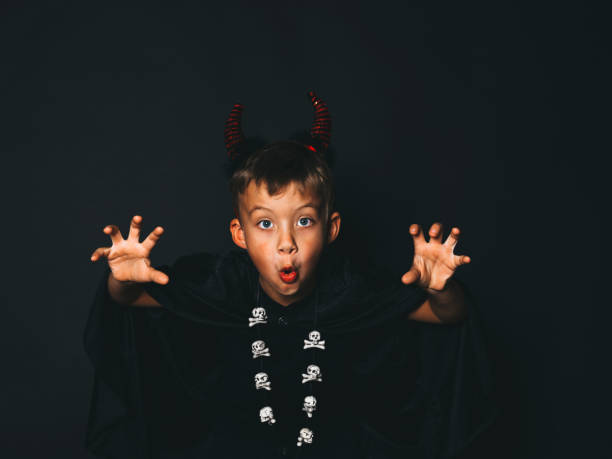 istock Portrait Of Boy Gesturing Against Black Background 1079719766