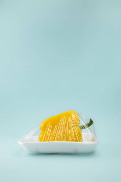 istock Fresh paprika in plastic wrap at seafoam green background 1079722696