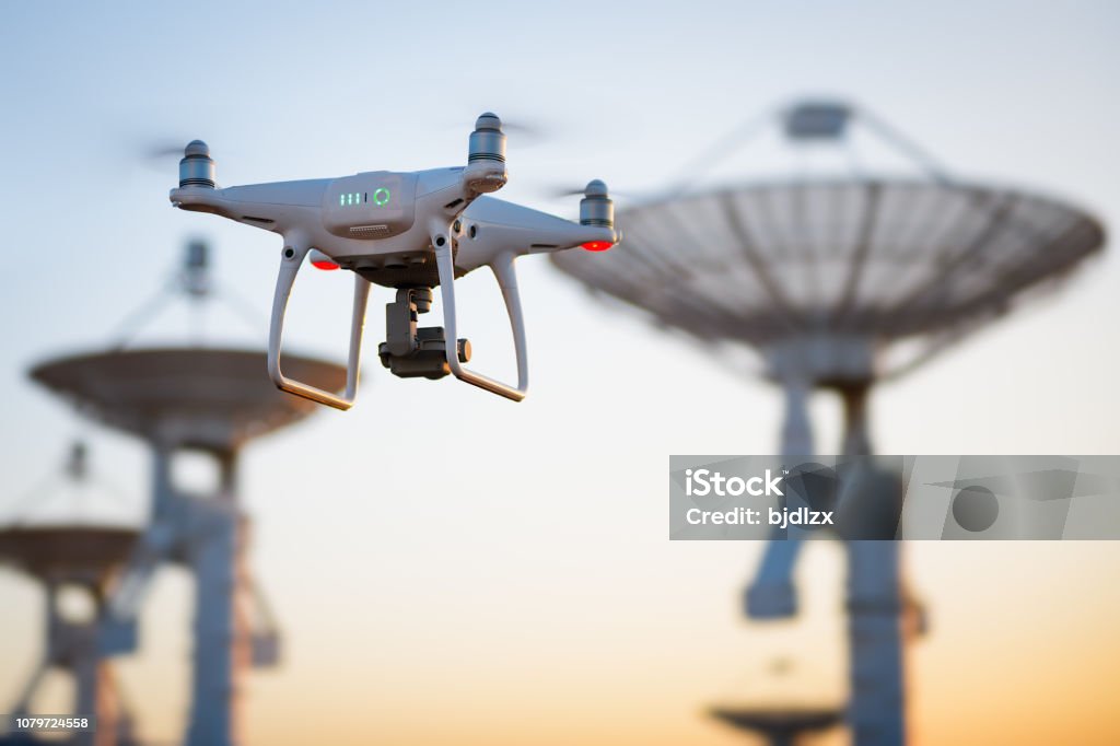 Drone flying at the Satellite antenna array Drone Stock Photo