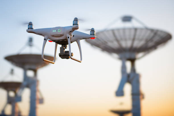 Drone flying at the Satellite antenna array stock photo
