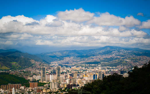 above view of Caracas city in Venezuela from Avila mountain during sunny cloudy summer day