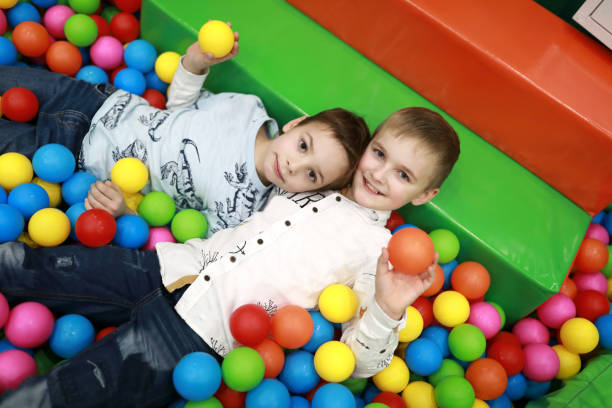 istock Brothers playing in ball pool 1079730396