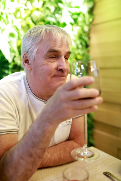 istock Man holding glass of wine 1079730724