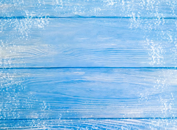istock blue painted old wooden background, snow 1079731040