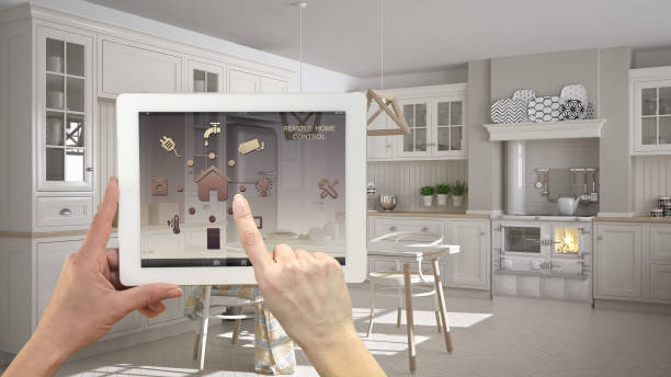 istock Smart remote home control system on a digital tablet. Device with app icons. Scandinavian classic kitchen with dining table and chairs in the background, architecture interior design 1079732734
