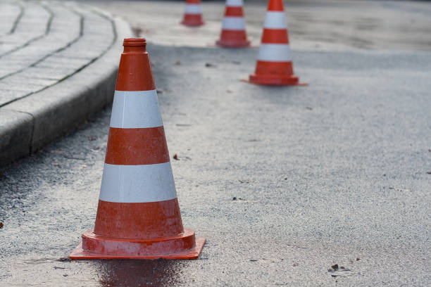 istock Red white road pylon on wet asphalt 1079733610