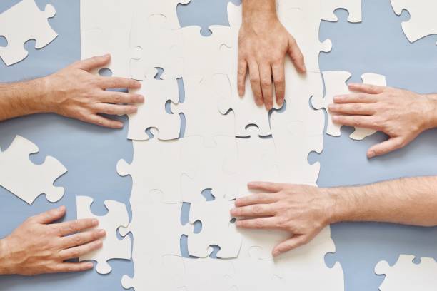 istock Close-Up Of Hand Arranging Jigsaw Puzzle 1079733990