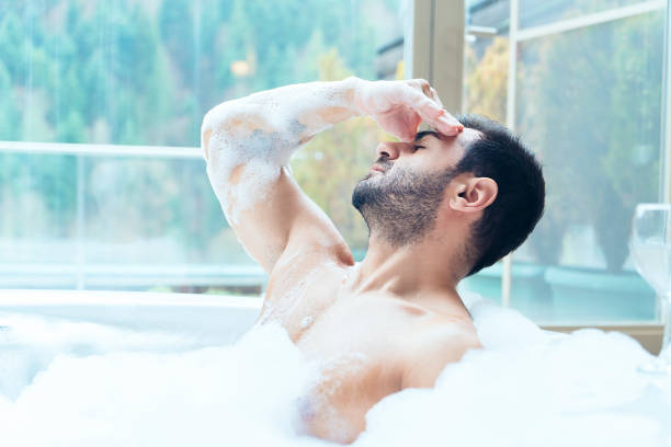 istock Man in a hot tub massaging his temple 1079736718