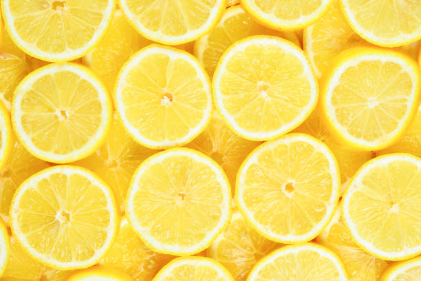 istock A slices of fresh juicy yellow lemons.  Texture background, pattern. 1079736810
