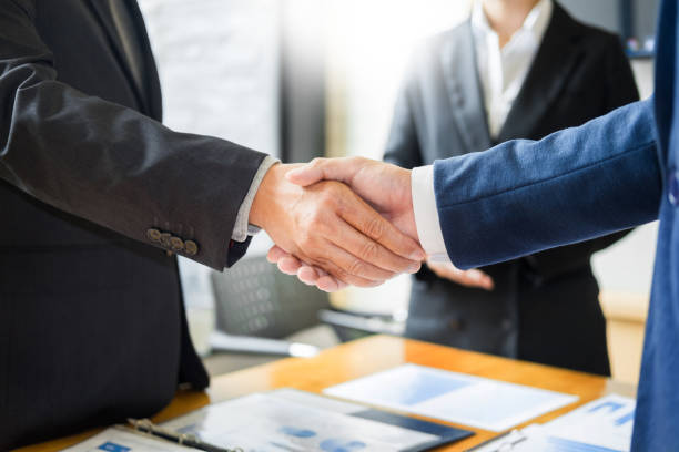istock Midsection Of Business People Doing Handshake 1079739112