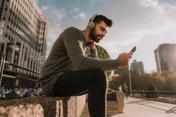 istock Young man listening with his headphones 1079739218