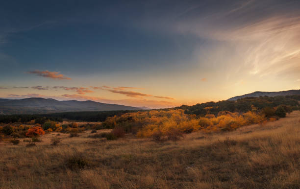 istock Autumn panoramic sunset in mountains with orange trees 1079747442