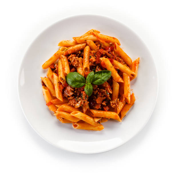 Pasta with meat, tomato sauce and vegetables Pasta with meat, tomato sauce and vegetables on white background bolognese sauce photos stock pictures, royalty-free photos & images