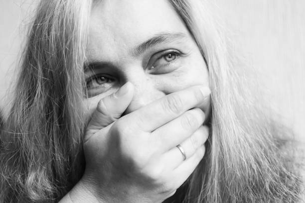 istock Young woman covers her face with her hand 1079748176
