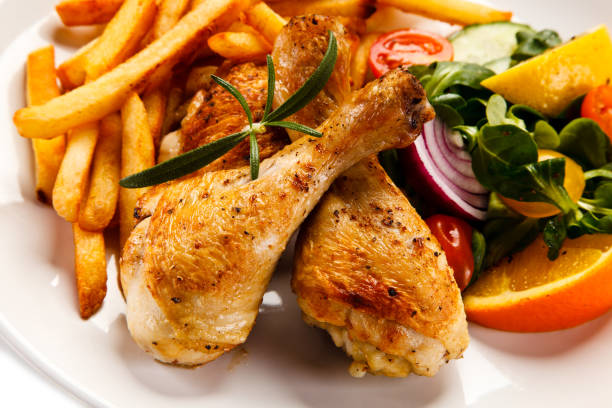 istock Roasted chicken drumsticks, French fries and vegetables 1079751280