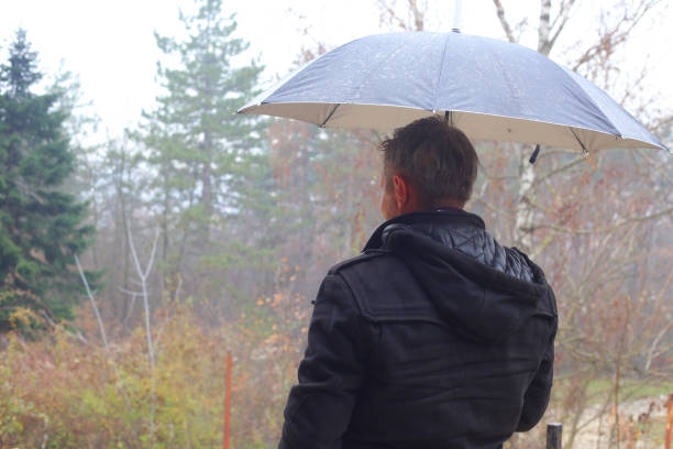 istock Handsome adult man outdoors on rainy autumn day 1079755522