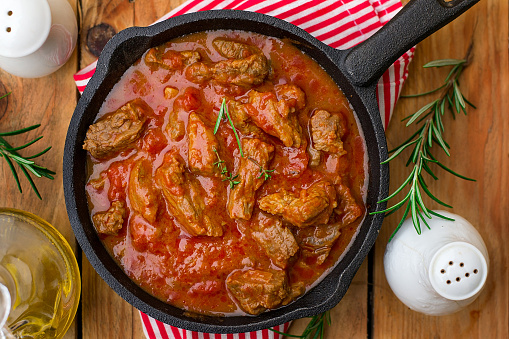 Beef stew with tomato sauce and cream and rosemary